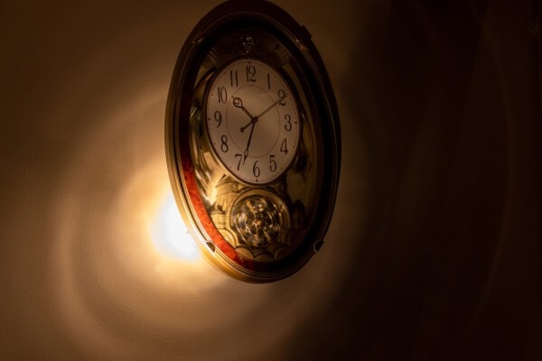using a flashlight to detect hidden camera lens reflections in a dark room